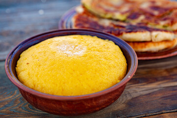 polenta is a dish made from corn flour, served with a book and cheese. Traditional food in Romania and the Republic of Moldova