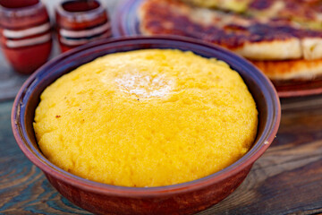 polenta is a dish made from corn flour, served with a book and cheese. Traditional food in Romania and the Republic of Moldova