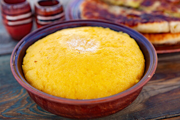polenta is a dish made from corn flour, served with a book and cheese. Traditional food in Romania and the Republic of Moldova