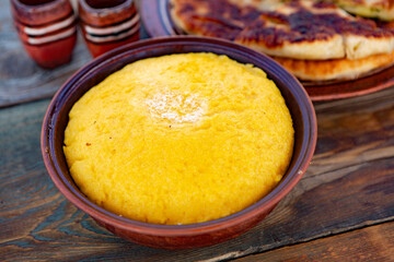 polenta is a dish made from corn flour, served with a book and cheese. Traditional food in Romania and the Republic of Moldova