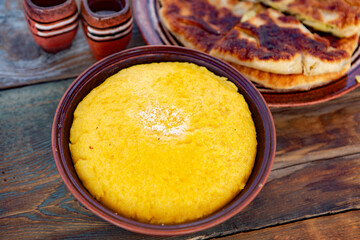 polenta is a dish made from corn flour, served with a book and cheese. Traditional food in Romania and the Republic of Moldova