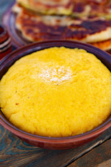 polenta is a dish made from corn flour, served with a book and cheese. Traditional food in Romania and the Republic of Moldova