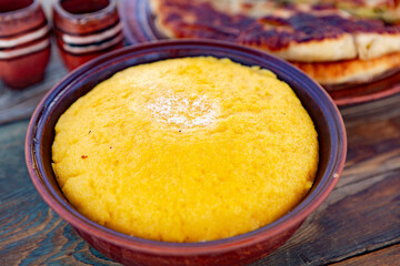 polenta is a dish made from corn flour, served with a book and cheese. Traditional food in Romania and the Republic of Moldova
