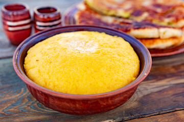 polenta is a dish made from corn flour, served with a book and cheese. Traditional food in Romania and the Republic of Moldova