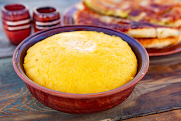 polenta is a dish made from corn flour, served with a book and cheese. Traditional food in Romania...