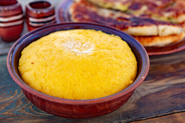 polenta is a dish made from corn flour, served with a book and cheese. Traditional food in Romania and the Republic of Moldova