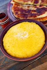 polenta is a dish made from corn flour, served with a book and cheese. Traditional food in Romania and the Republic of Moldova