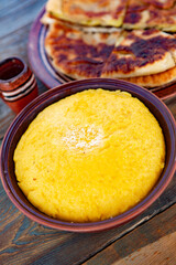 polenta is a dish made from corn flour, served with a book and cheese. Traditional food in Romania and the Republic of Moldova