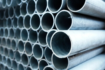 New metal pipes of same diameter are stacked. Pipes for gasification or water supply. Industrial...