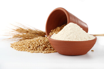 Wheat flour Bunch of wheat ears, dried grains in terracotta bowl, flour in terracotta bowl on white...