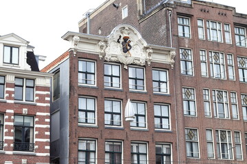 Amsterdam Rokin Street Historic Brick Building Facades with Stone Tablet Depicting a Black Man Wearing a Quiver and Holding a Bow and an Arrow, Netherlands