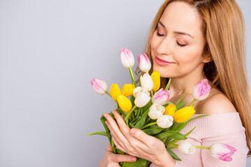 Cropped photo of charming lovely lady closed eyes smell fresh tulips isolated on grey color background