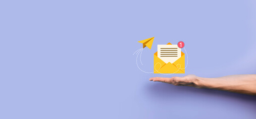 Businessman hand holding letter icon,email icons.Contact us by newsletter email and protect your personal information from spam mail.Customer service call center contact us.Email marketing newsletter.