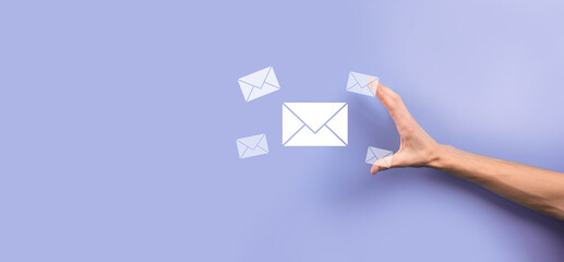 Businessman hand holding letter icon,email icons.Contact us by newsletter email and protect your personal information from spam mail.Customer service call center contact us.Email marketing newsletter.