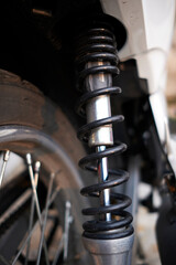 Black motorcycle suspension with shock absorber. The springy flexibility of the machine. Jumping into the air