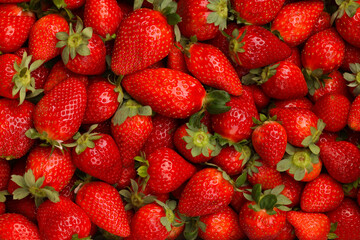 Background of fresh ripe red scattered strawberries