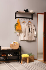 Hallway interior with stylish furniture, clothes and accessories