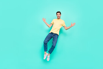 Fototapeta na wymiar Full size photo of overjoyed energetic person jump fly have good mood isolated on turquoise color background