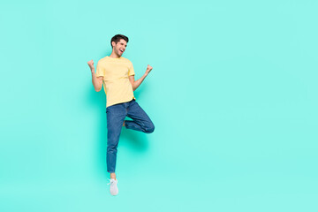 Full size portrait of delighted satisfied person raise fists shout yes look empty space isolated on teal color background