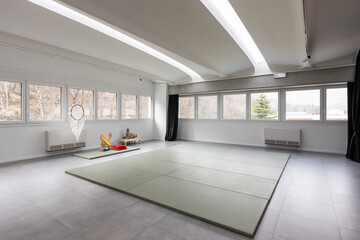 Bright studio with yoga and exercise mats with large windows. There is peace and quiet
