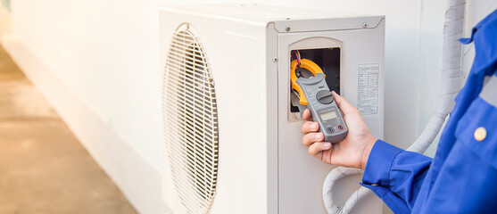 Air conditioner repairman using electricity meter to check air conditioner operation, maintenance...
