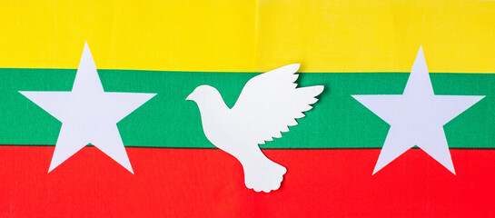 Support for Myanmar people, peace dove with flag of Myanmar. Freedom, stop war, dictatorship and democracy concepts