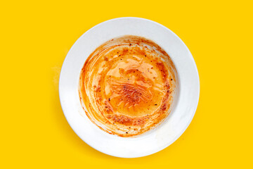 Dirty dish on yellow background. Top view