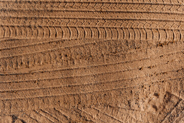 Car wheel tracks on dry sand
