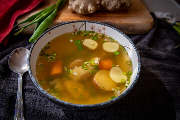 A bowl of ginger, onion soup with vegetables. Fat free and full of goodness especially when one is feeling unwell.