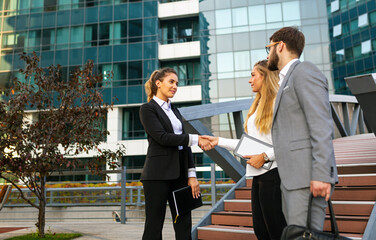 Group of business man and woman team at office shaking hands outdoors