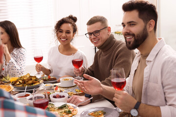 Group of people having brunch together at table indoors