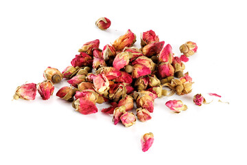An addition to traditional or herbal tea - dried rosebuds on a white background.