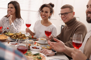 Group of people having brunch together at table indoors