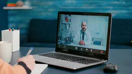 Female patient meeting with doctor on online video call consultation to ask about disease treatment...