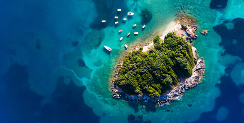 Fototapeta na wymiar Coast as a background from top view. Turquoise water background from top view. Summer seascape from air.