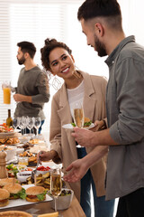 Young couple enjoying brunch buffet together indoors