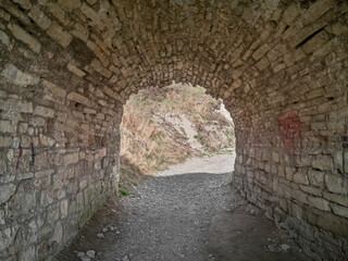 Exit from the old medieval dark brick arched fortification tunnel.