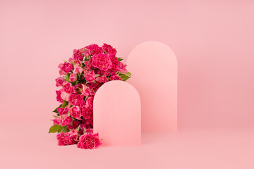 Fresh pink roses as arch, empty rounded doors as two podiums on abstract pink scene mockup for...