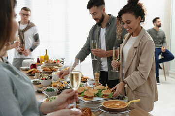 Group of people enjoying brunch buffet together indoors