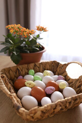 chicken eggs lie with a straw basket on wooden background.. Top view. Free space. Easter eggs. High quality photo