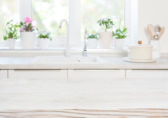 Fototapeta na wymiar Wooden table on blurred background of kitchen blurred sink window