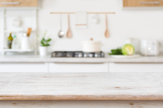 Blurred kitchen background with wooden table top for in front