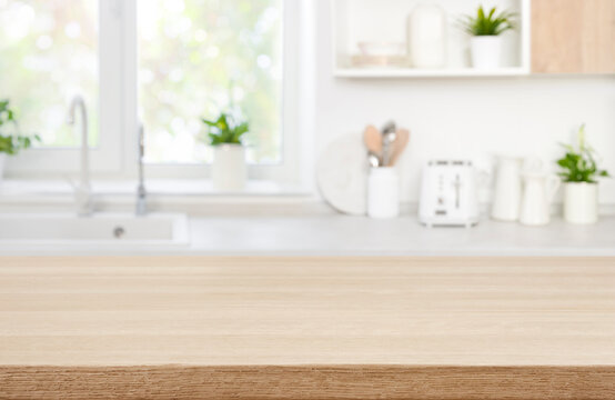 Wood table top on blur modern kitchen room counter background