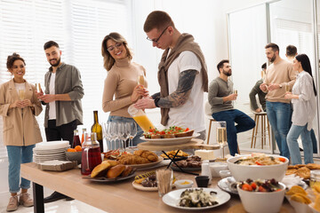 Group of people enjoying brunch buffet together indoors