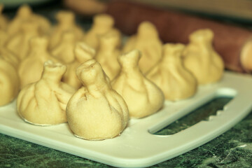 cook in the kitchen to prepare delicious healthy khinkali