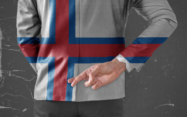 Businessman Jacket with Flag of Faroe Islands with his fingers crossed behind his back