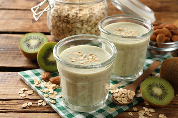 Tasty kiwi smoothie with oatmeal on wooden table