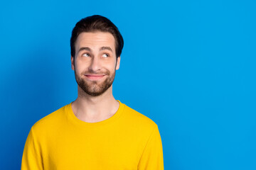 Portrait of attractive cheerful cunning brunet guy creating solution isolated over vibrant blue...