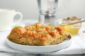 Delicious sweet baklava on white marble table, closeup