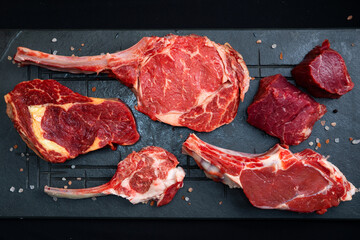 raw tomahawk with rosemary on a wooden board